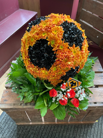 Wolves Football Tribute - A striking Wolves football tribute, handcrafted in the club’s iconic orange and black colours by Pursehouse Florist in Cannock for a devoted supporter.