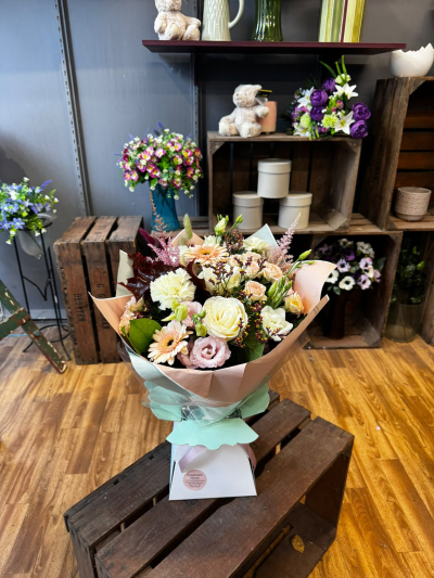 Peach Perfection - A beautiful arrangement featuring a delicate blend of soft peach, blush pink and creamy ivory tones, complemented by seasonal foliage. Lovingly arranged and presented in a stylish gift bag, this elegant design makes a thoughtful gift for birthdays, anniversaries or any occasion worth celebrating.