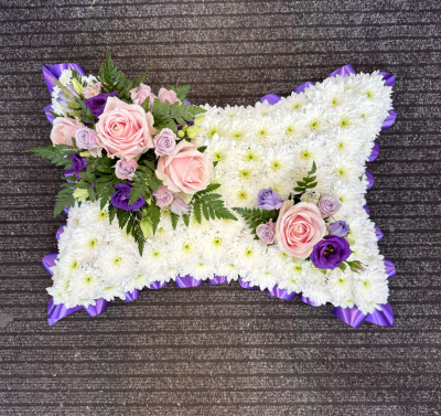Peaceful Dreams - A beautifully crafted funeral pillow featuring a soft white base, delicate pink and lilac accents and touches of rich purple. Finished with an elegant purple ribbon, this traditional tribute is a gentle expression of love, comfort and remembrance, offering a heartfelt way to honour someone who will always be remembered.
